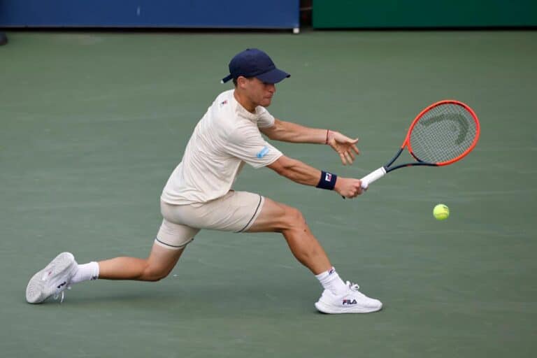 Argentina's Diego Schwartzman returns the ball to France's Gael Monfils during their men's singles first round tennis match on day one of the US Open tennis tournament at the USTA Billie Jean King National Tennis Center in New York City, on August 26, 2024.