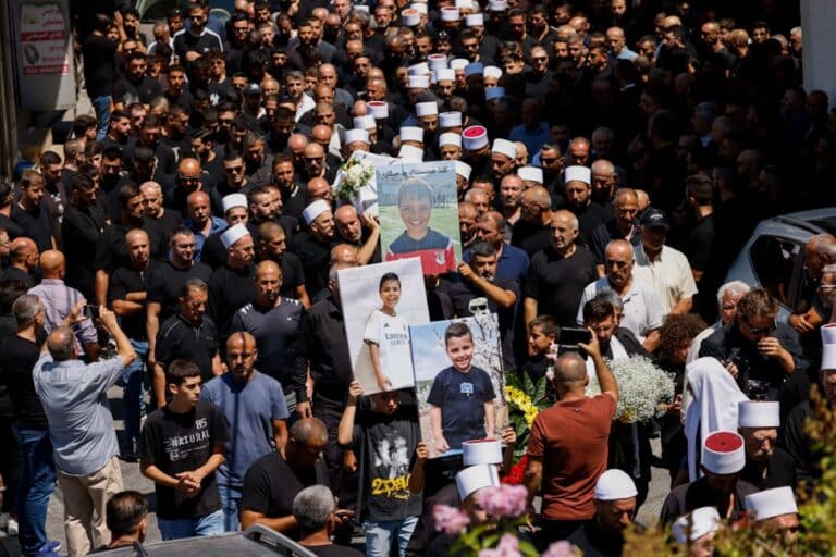 Elders and mourners carry the coffin of Guevara Ibrahim, 11, killed in a reported strike from Lebanon two days earlier, during his funeral in the Druze town of Majdal Shams in the Israeli-annexed Golan on July 29, 2024.