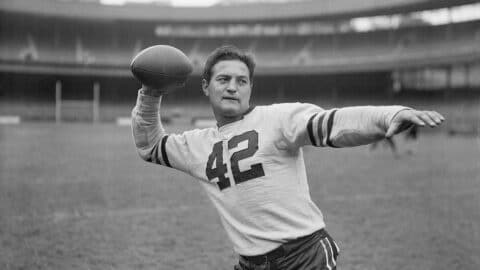 New York, New York: Sid Luckman, a local boy who made good with the grid warriors of Columbia University, shows off the passing technique that won him honors and a place with the Chicago Bears professional football team. He was photographed today during a workout of the Bears at the New York Polo Grounds, where the Bears will clash with the New York Giants on Sunday.