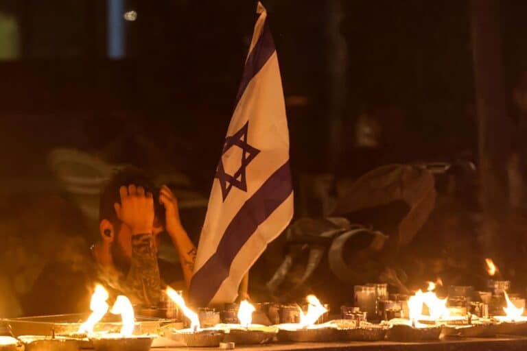 A man reacts at a makeshift memorial on October 18, 2023 for the victims of an attack by Hamas terrorists on Israel on October 7 at Dizengoff Square in Tel Aviv.