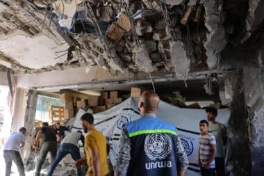 A United Nations Relief and Works Agency for Palestine Refugees (UNRWA) worker and displaced Palestinians check the damage inside a UN school-turned-refuge in the Al-Shati refugee camp near Gaza City in the northern Gaza Strip, following a reported Israeli strike on October 19, 2024.