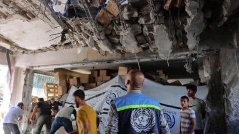 A United Nations Relief and Works Agency for Palestine Refugees (UNRWA) worker and displaced Palestinians check the damage inside a UN school-turned-refuge in the Al-Shati refugee camp near Gaza City in the northern Gaza Strip, following a reported Israeli strike on October 19, 2024.