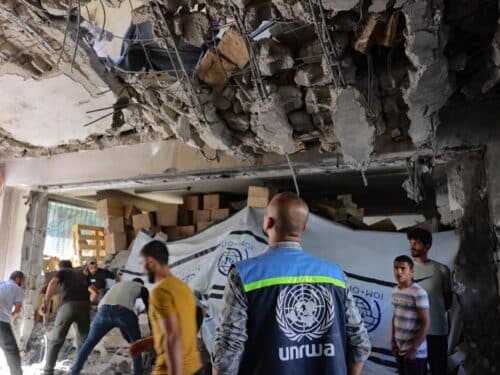 A United Nations Relief and Works Agency for Palestine Refugees (UNRWA) worker and displaced Palestinians check the damage inside a UN school-turned-refuge in the Al-Shati refugee camp near Gaza City in the northern Gaza Strip, following a reported Israeli strike on October 19, 2024.