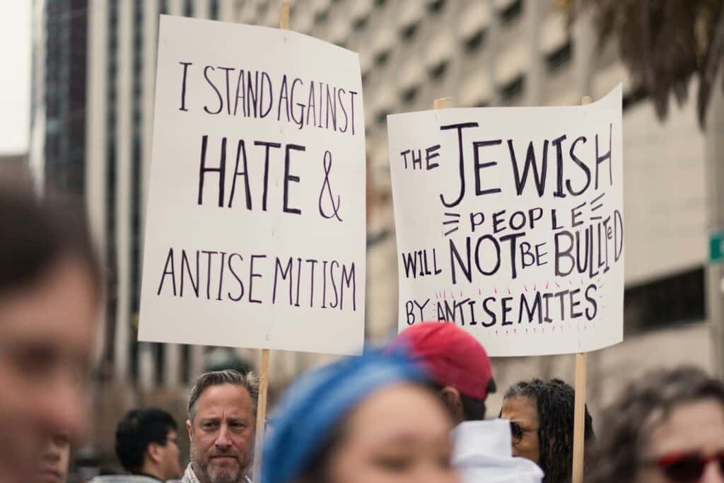 Signs supporting the Jewish community at a march against antisemitism (Photo by Levi Meir Clancy).